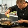 Professional chef demonstrating cooking with margarine in a stainless steel pan, highlighting techniques for perfect searing and flavor mastery