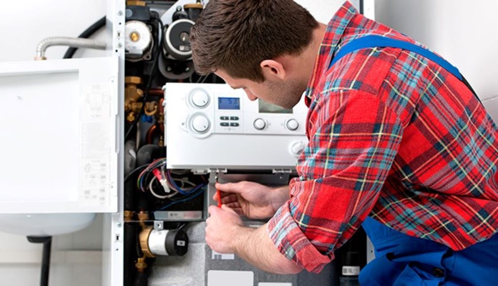 Homeowner inspecting a malfunctioning boiler in Leeds, highlighting common boiler problems and repair solutions