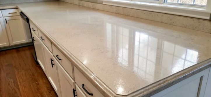 Painted laminate kitchen countertop makeover showing a smooth, modern finish in neutral tones, demonstrating an affordable DIY kitchen transformation