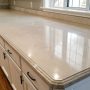 Painted laminate kitchen countertop makeover showing a smooth, modern finish in neutral tones, demonstrating an affordable DIY kitchen transformation