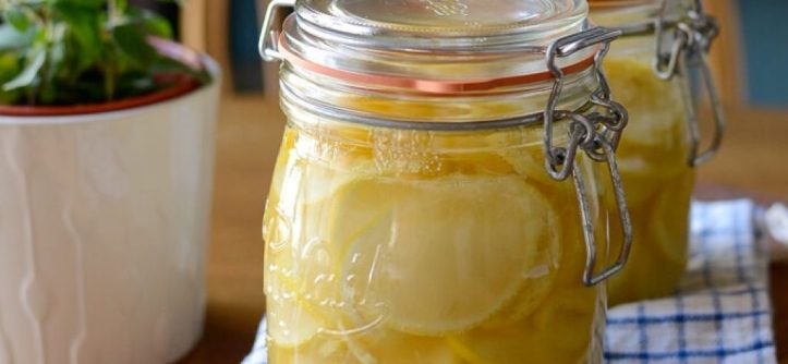 Alt Text 1: A clear glass jar of homemade allulose syrup sits on a clean kitchen counter next to a bag of granulated allulose
