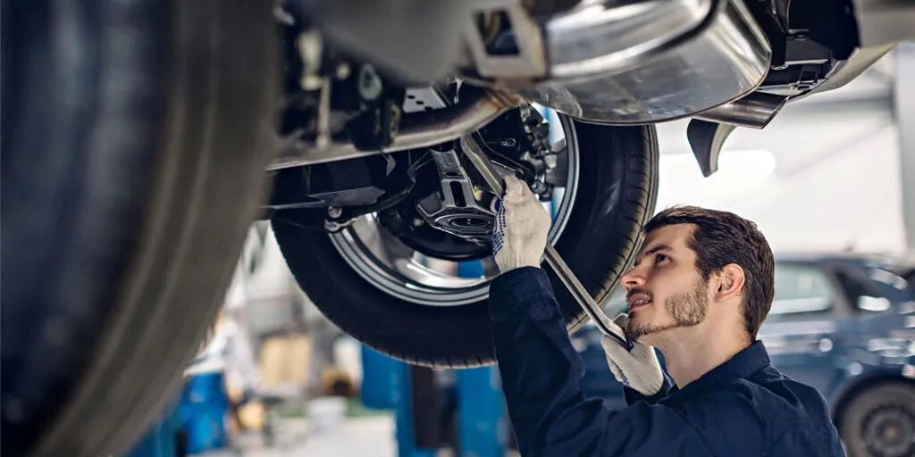 Mechanic performing regular garage maintenance as part of a subscription service in Canada