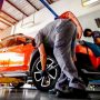 Mechanic performing regular garage maintenance as part of a subscription service in Canada