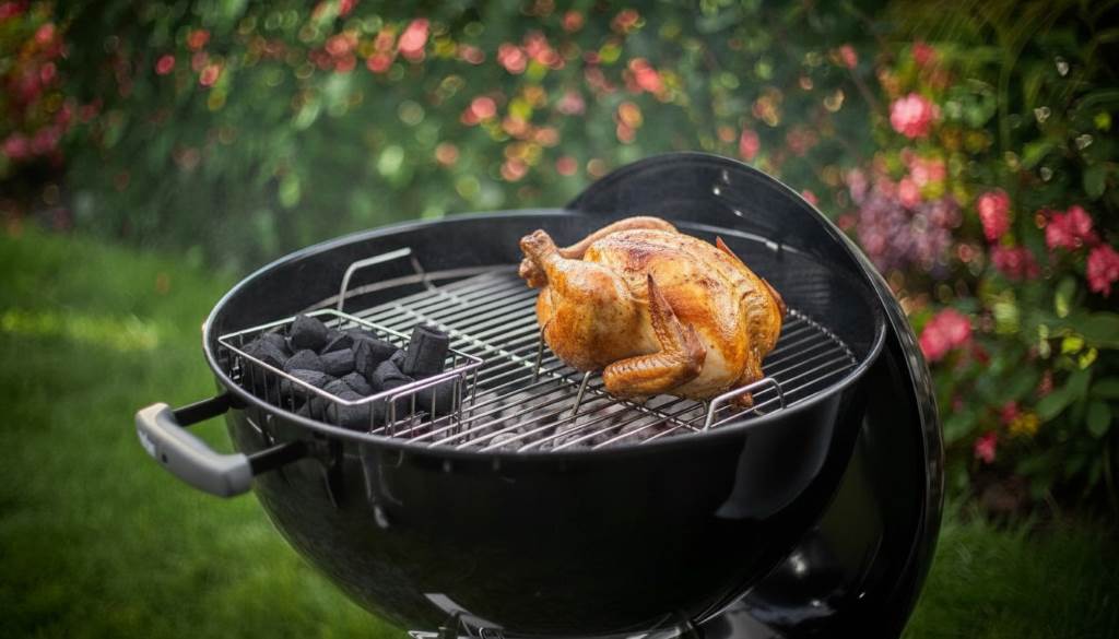 Weber Original Kettle 22-Inch set up for indirect grilling with coals banked and chicken roasting