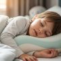 Child sleeping comfortably on age-appropriate pillow with proper neck alignment and spine support