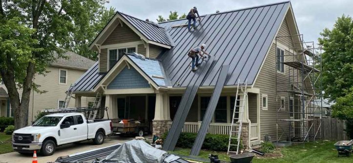 Homeowner reviewing a metal roof estimate with a roofing contractor