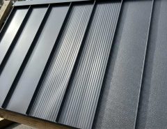 Striated metal roof panel showing shallow grooves along the pan