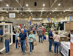 Visitors browsing remodeling booths inside the Tucson Convention Center exhibit hall