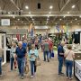 Visitors browsing remodeling booths inside the Tucson Convention Center exhibit hall