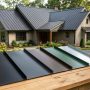 White farmhouse with a charcoal metal roof and black window trim