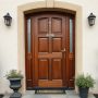 A wooden front door with glass side panels set in a beige wall between two white windows.