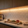 LED strip lights mounted under kitchen cabinets illuminating the countertop