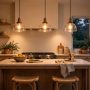 Pendant lights over a kitchen island glowing in warm 3000K light