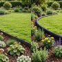 Two garden borders side by side, one with slim dark steel edging and one with flexible black plastic edging