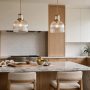 Two pendant lights hanging over a kitchen island at the correct height